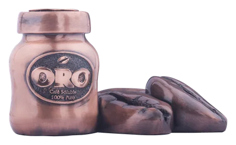 A Café Oro coffee jar with coffee beans beside it, finished in copper