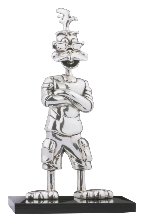 The Lucas candy mascot standing with crossed arms, sculpted in silver on a black base